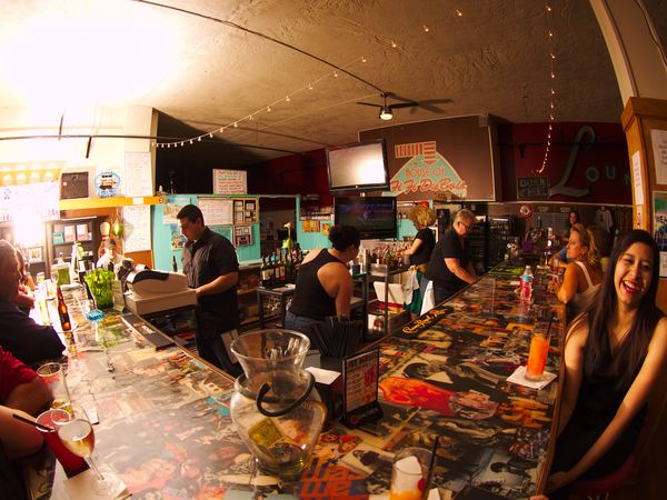 The bar at Fifi's with the crowd and bartenders
