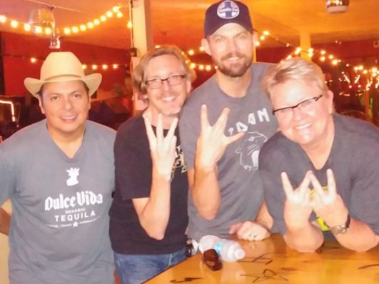 Friends at the bar under the Fifi's sign