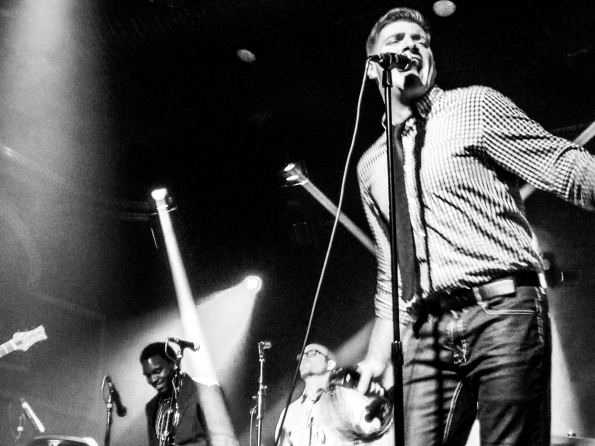 Singer and band in black and white