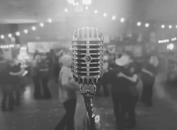 Vintage microphone in front of couples dancing
